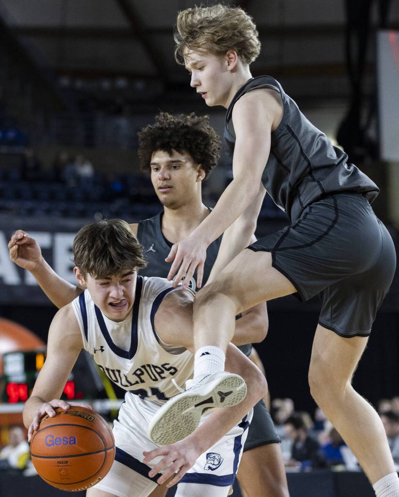Glacier Peaks Reed Nagel leaps in the air to try and get a rebound during overtime at the 4A boys semifinal game against Gonzaga Prep on Friday, March 7, 2025 in Tacoma, Washington. (Olivia Vanni / The Herald)
