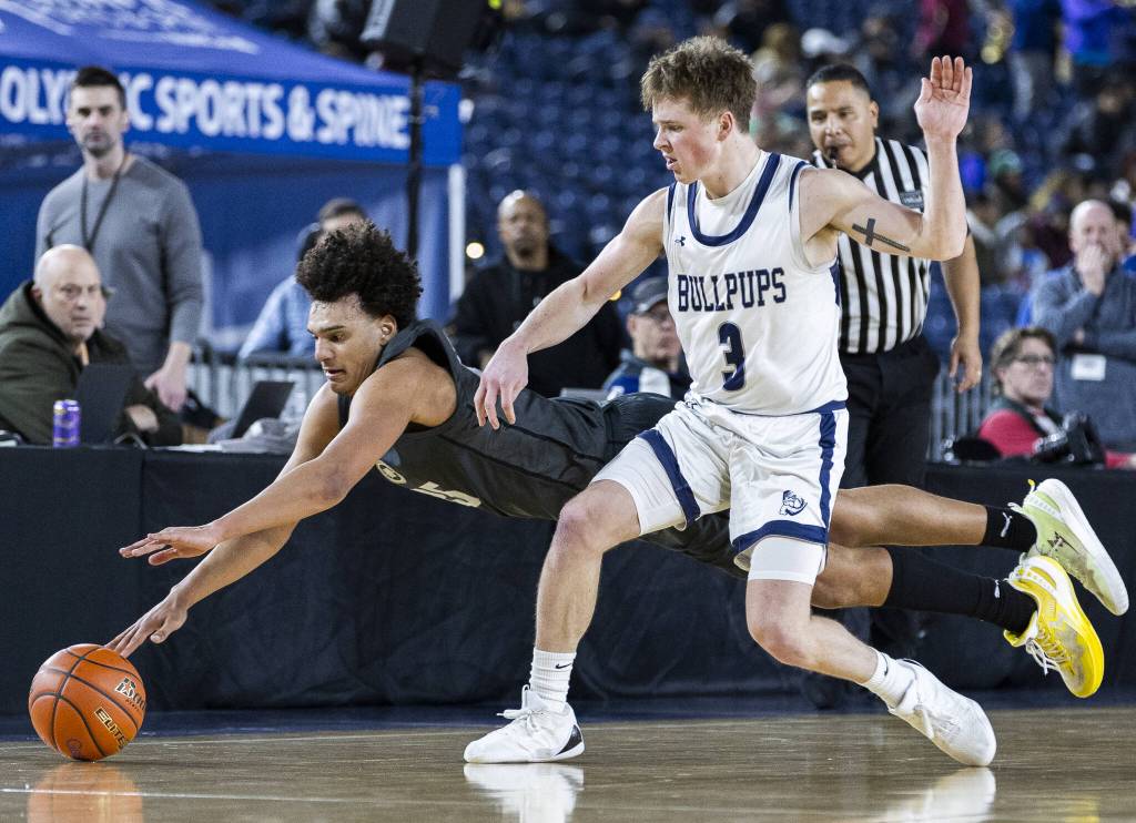 Glacier Peaks Jayce Nelson leaps for a loose ball during the 4A boys semifinal game against Gonzaga Prep on Friday, March 7, 2025 in Tacoma, Washington. (Olivia Vanni / The Herald)