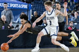Glacier Peak’s Jayce Nelson leaps for a loose ball during the 4A boys semifinal game against Gonzaga Prep on Friday, March 7, 2025 in Tacoma, Washington. (Olivia Vanni / The Herald)