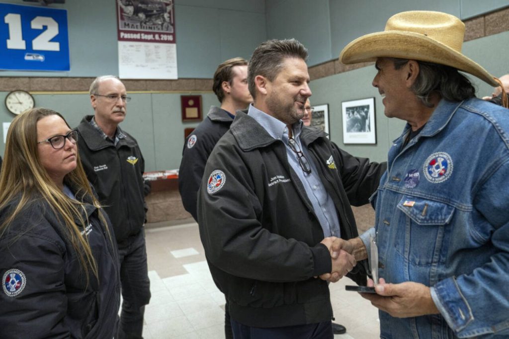 Jon Holden, center, president of District 751 of the International Association of Machinists and Aerospace Workers, greets members in Seattle on Monday night, Nov. 4, 2024. Even with a strike ending, Boeing and its new chief executive face a daunting to-do list, including improving quality and increasing production of its commercial planes.  (M. Scott Brauer/The New York Times)