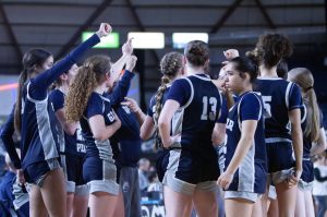 The Glacier Peak girls basketball team huddles at the end of a timeout during a March 5, 2025 state playoff game at the Tacoma Dome. (Qasim Ali / The Herald)