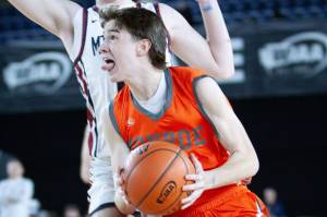 Monroe's Isaiah Kiehl fights through contact for a layup during a March 5, 2025 state playoff game against Mt. Spokane at the Tacoma Dome. (Qasim Ali / The Herald)