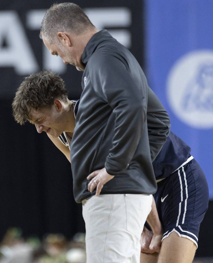 Glacier Peaks Jo Lee grimaces while coming off the court before overtime during the 4A boys quarterfinal game against Camas on Thursday, March 6, 2025 in Tacoma, Washington. (Olivia Vanni / The Herald)