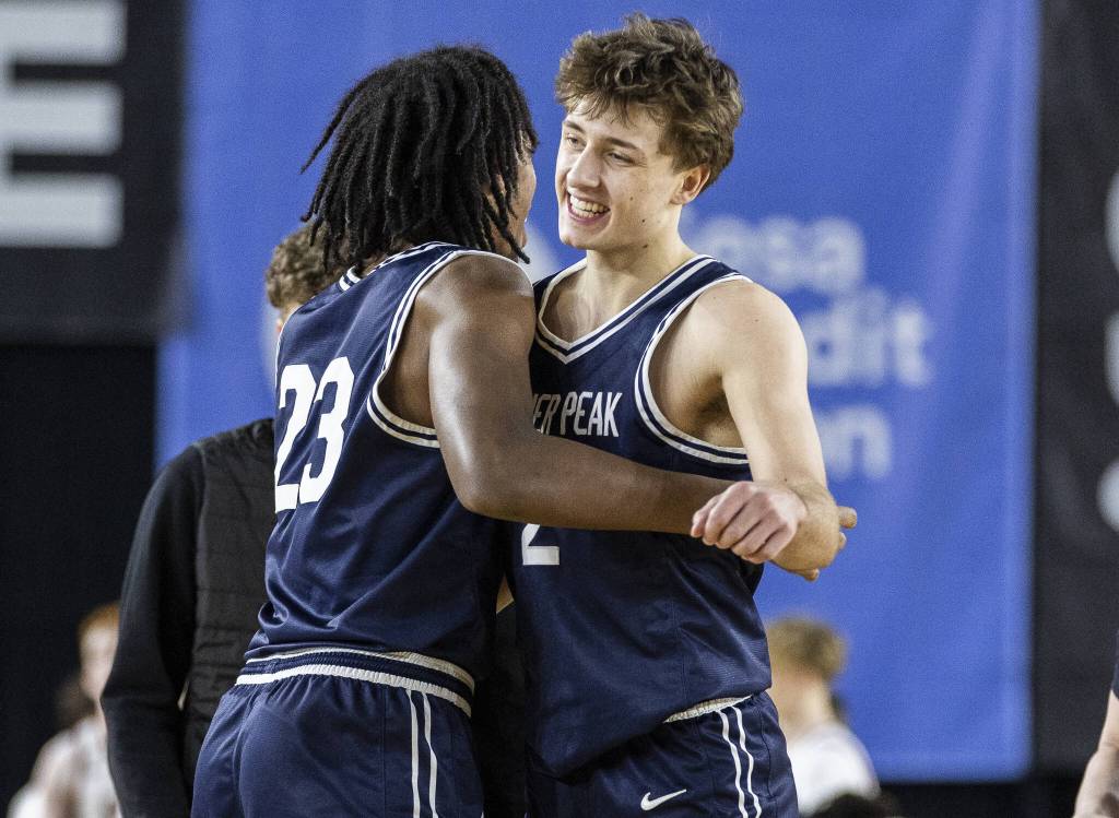 Glacier Peaks Jo Lee is hugged by his teammate Paulos Mulugeta after winning the 4A boys quarterfinal game against Camas on Thursday, March 6, 2025 in Tacoma, Washington. (Olivia Vanni / The Herald)