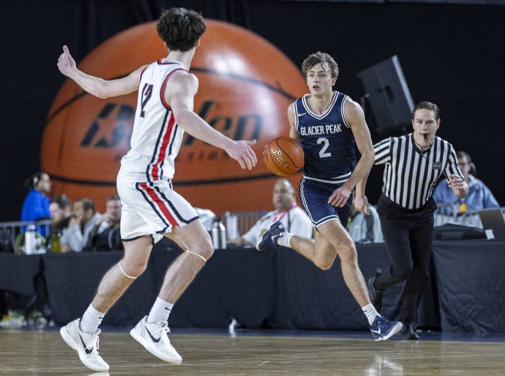 Glacier Peaks Jo Lee takes the ball down the court during the 4A boys quarterfinal game against Camas on Thursday, March 6, 2025 in Tacoma, Washington. (Olivia Vanni / The Herald)