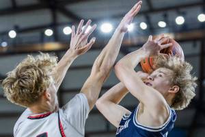 Glacier Peak’s Reed Nagel makes a layup while being guarded during the 4A boys quarterfinal game against Camas on Thursday, March 6, 2025 in Tacoma, Washington. (Olivia Vanni / The Herald)