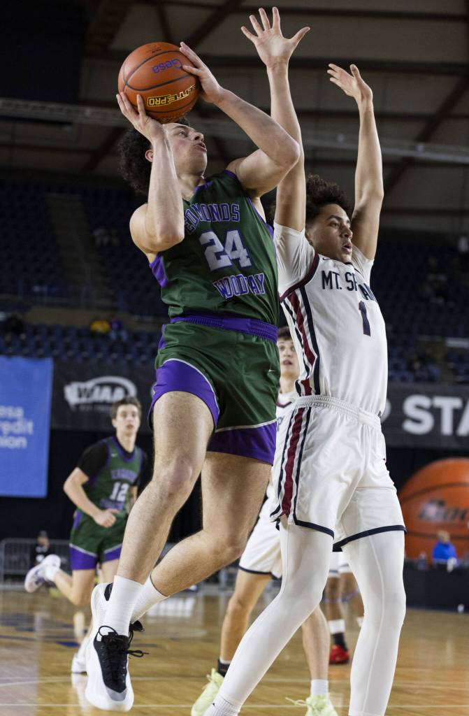 Edmonds-Woodways Julian Gray jumps in the air to make a layup during the 3A boys semifinal game against Mt. Spokane on Friday, March 7, 2025 in Tacoma, Washington. (Olivia Vanni / The Herald)