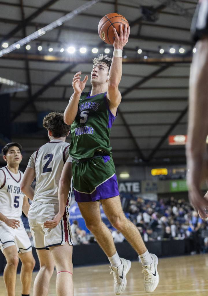 Edmonds-Woodways Cameron Hiatt leaps in the air to make a layup during the 3A boys semifinal game against Mt. Spokane on Friday, March 7, 2025 in Tacoma, Washington. (Olivia Vanni / The Herald)