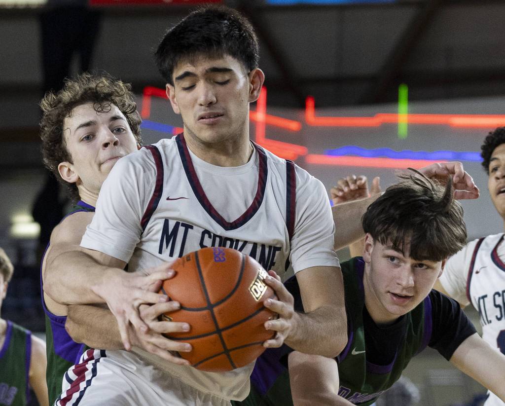 Edmonds-Woodways Cameron Hiatt and Grant Williams tries to steal the ball from Mt. Spokanes Nalu Vargas during the 3A boys semifinal game on Friday, March 7, 2025 in Tacoma, Washington. (Olivia Vanni / The Herald)