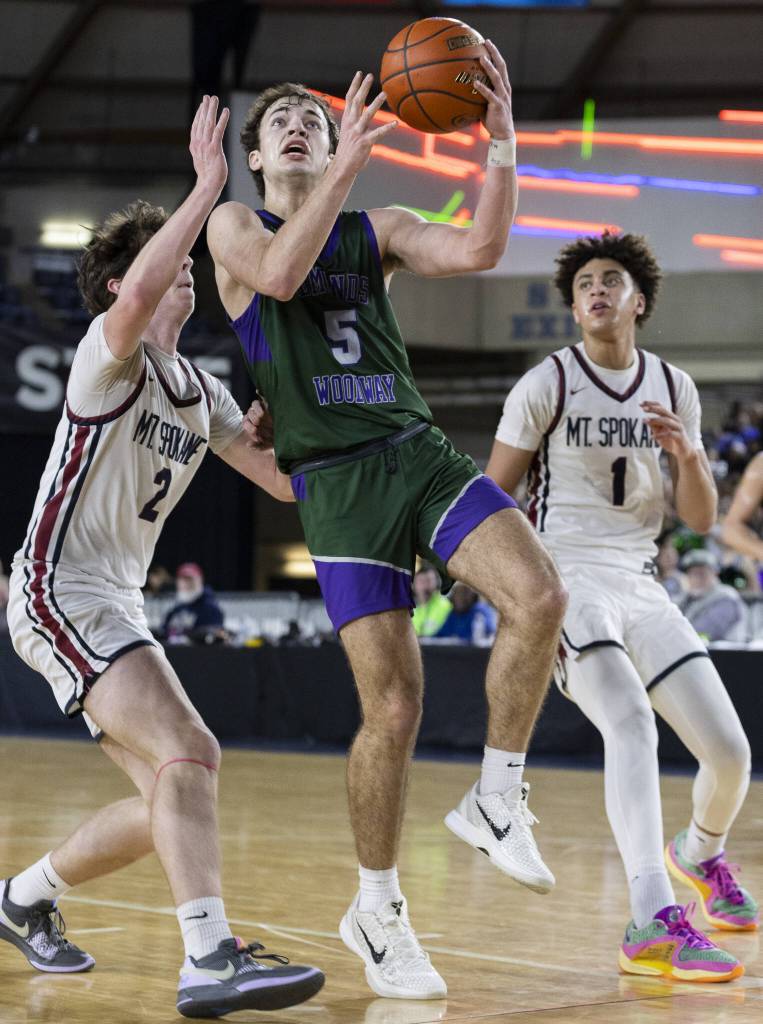 Edmonds-Woodways Cameron Hiatt reaches up to make a layup during the 3A boys semifinal game against Mt. Spokane on Friday, March 7, 2025 in Tacoma, Washington. (Olivia Vanni / The Herald)