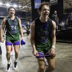 Edmonds-Woodways Cameron Hiatt runs with the Edmonds-Woodway label to place it on the championship game on the bracket poster on Friday, March 7, 2025 in Tacoma, Washington. (Olivia Vanni / The Herald)