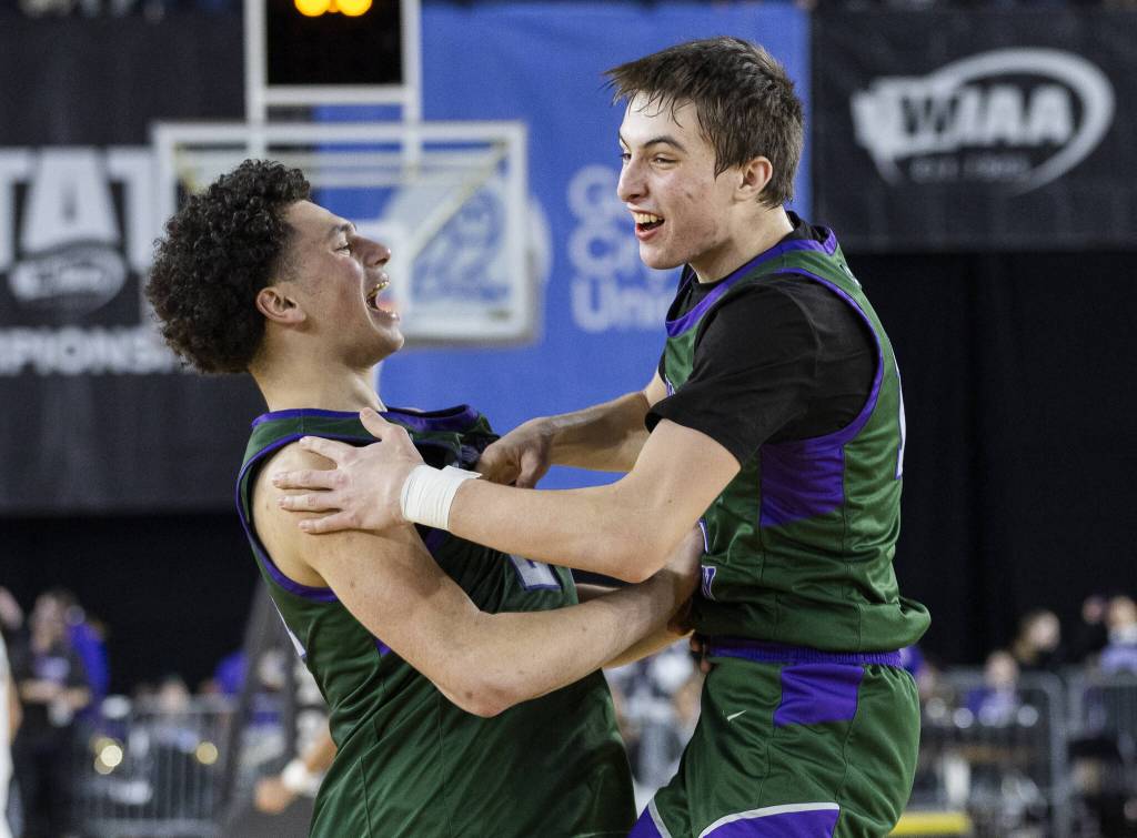 Edmonds-Woodways Julian Gray and William Alseth celebrate winning the 3A boys semifinal game against Mt. Spokane to advance to the state championship on Friday, March 7, 2025 in Tacoma, Washington. (Olivia Vanni / The Herald)