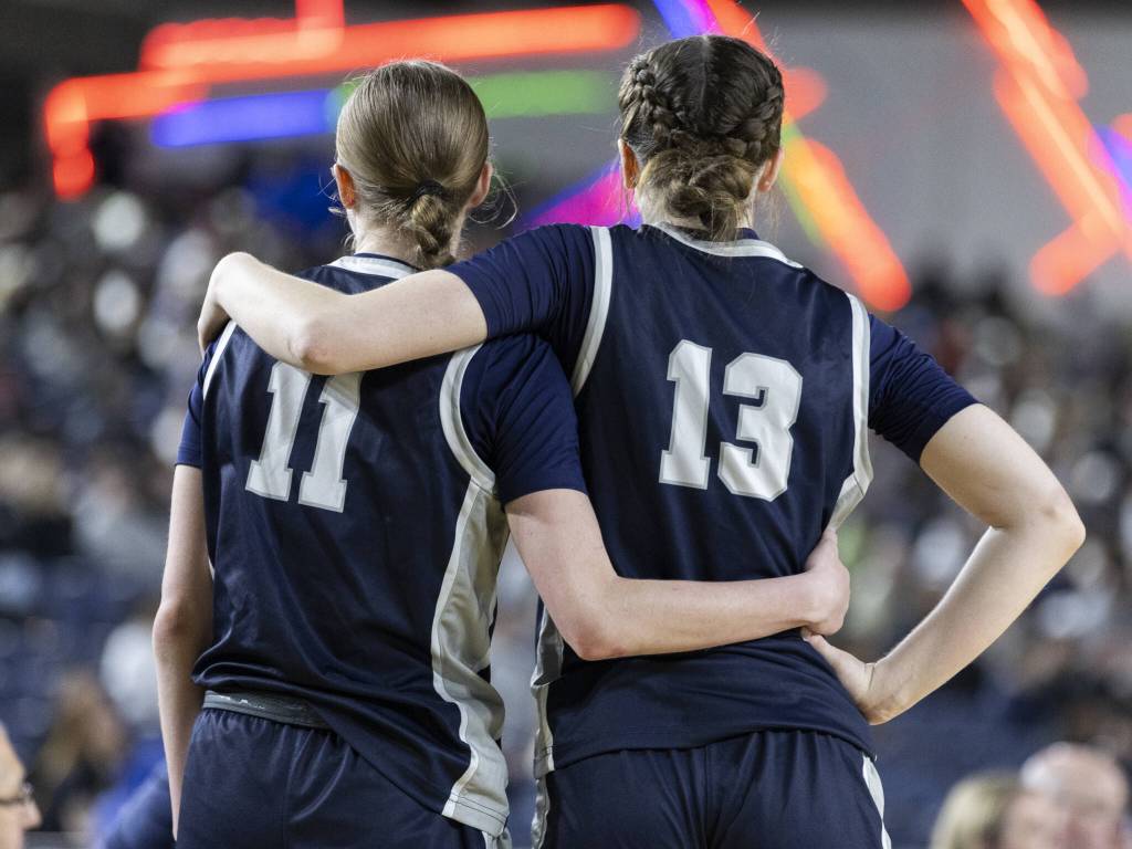 Glacier Peaks Samantha Thoma puts her arm around teammate Zoey Ritter during the 4A girls semifinal game against Davis on Friday, March 7, 2025 in Tacoma, Washington. (Olivia Vanni / The Herald)