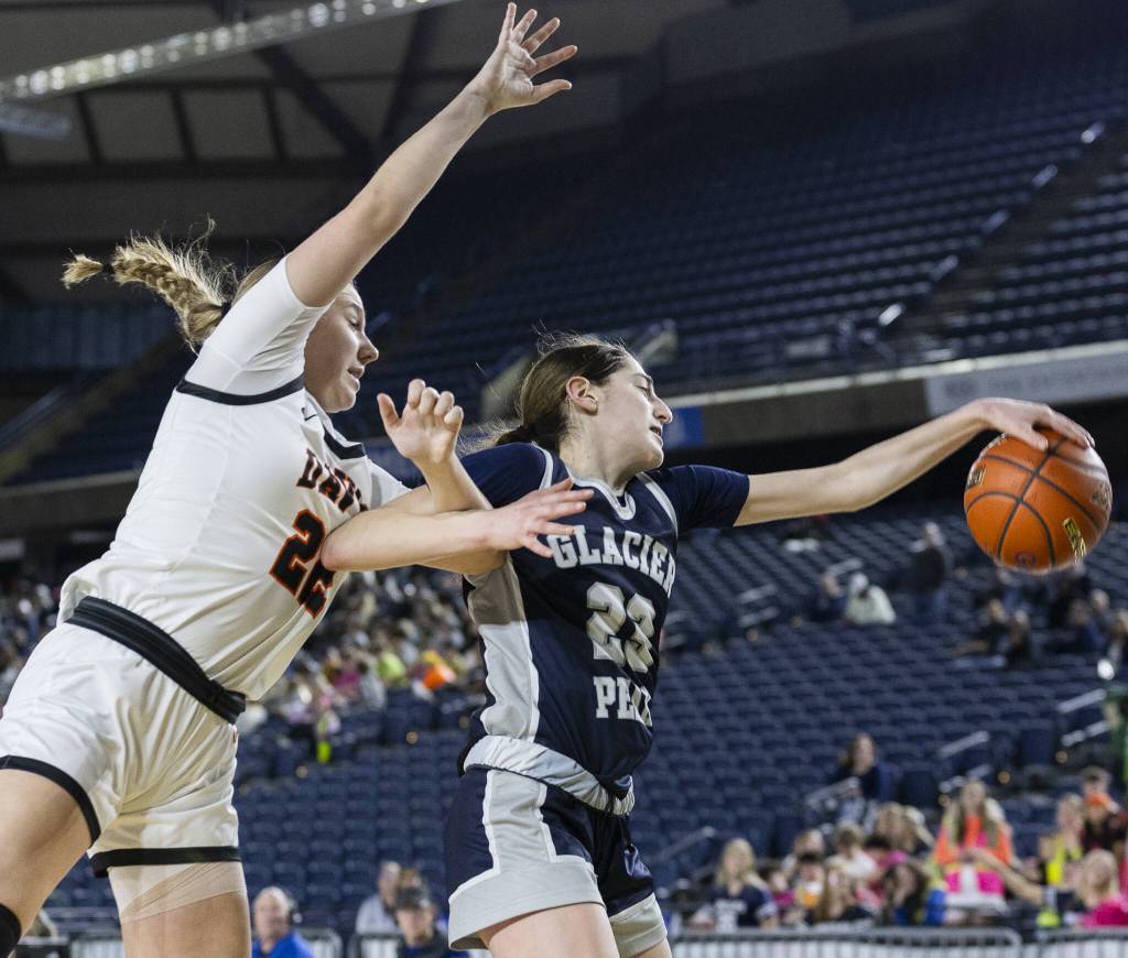 Glacier Peaks Lillian Riechelson reaches out for a loose ball during the 4A girls semifinal game against Davis on Friday, March 7, 2025 in Tacoma, Washington. (Olivia Vanni / The Herald)