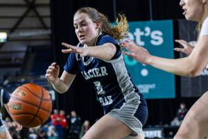 Glacier Peak’s Brynna Pukis reaches out for a loose ball during the 4A girls semifinal game against Davis on Friday, March 7, 2025 in Tacoma, Washington. (Olivia Vanni / The Herald)