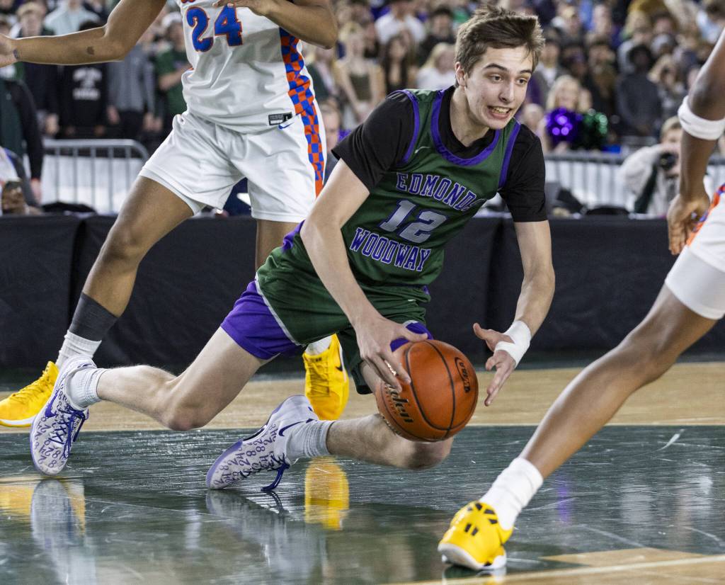 Edmonds-Woodways William Alseth falls to the ground during the 3A boys championship game against Rainier Beach on Saturday, March 8, 2025 in Tacoma, Washington. (Olivia Vanni / The Herald)