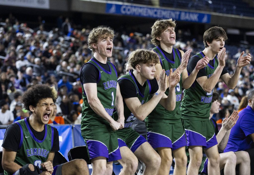 The Edmonds-Woodway bench reacts to a shot during the 3A boys championship game against Rainier Beach on Saturday, March 8, 2025 in Tacoma, Washington. (Olivia Vanni / The Herald)