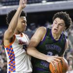 Edmonds-Woodways Julian Gray tries to maneuver around Rainier Beachs Kaden Powers during the 3A boys championship game on Saturday, March 8, 2025 in Tacoma, Washington. (Olivia Vanni / The Herald)