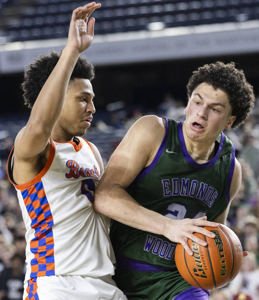Edmonds-Woodways Julian Gray tries to maneuver around Rainier Beachs Kaden Powers during the 3A boys championship game on Saturday, March 8, 2025 in Tacoma, Washington. (Olivia Vanni / The Herald)