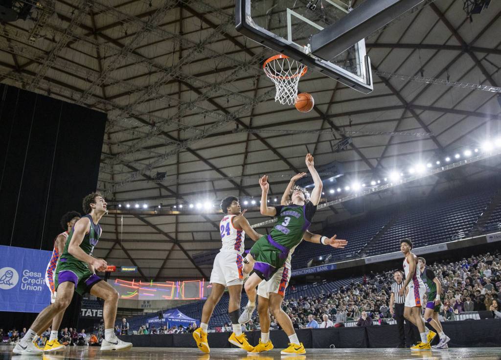 Edmonds-Woodways Grant Williams falls after attempting a layup during the 3A boys championship game against Rainier Beach on Saturday, March 8, 2025 in Tacoma, Washington. (Olivia Vanni / The Herald)