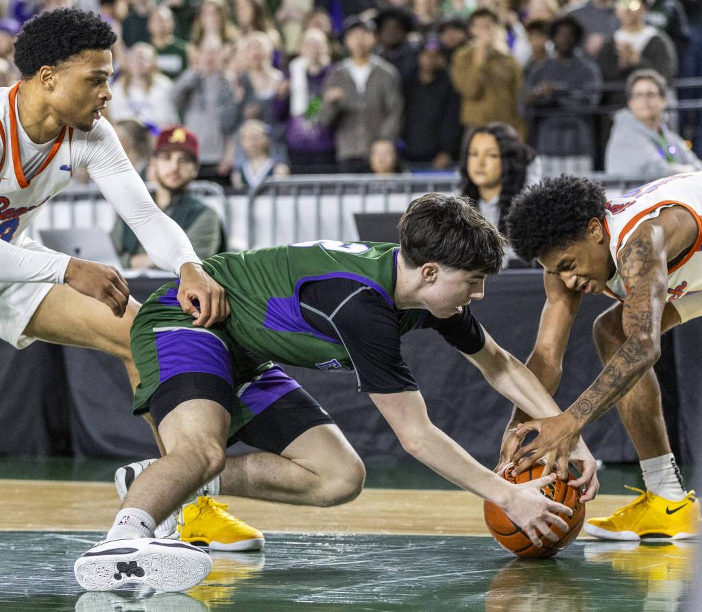 Edmonds-Woodways Dre Simonsen scrambles for a loose ball during the 3A boys championship game against Rainier Beach on Saturday, March 8, 2025 in Tacoma, Washington. (Olivia Vanni / The Herald)