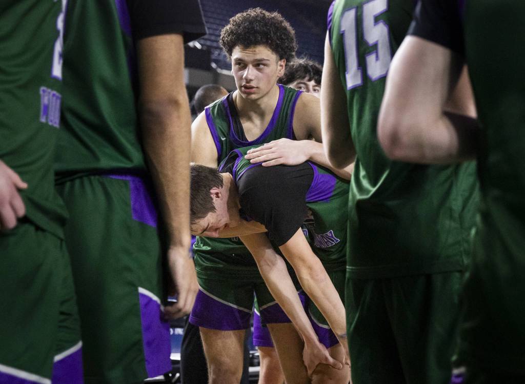 Edmonds-Woodways Julian Gray comforts his teammate William Alseth as he cries after losing the 3A boys championship game to Rainier Beach on Saturday, March 8, 2025 in Tacoma, Washington. (Olivia Vanni / The Herald)