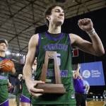 Edmonds-Woodways Cam Hiatt brings th 3A boys second place trophy over the the fan section and raises his fist in thanks to fans on Saturday, March 8, 2025 in Tacoma, Washington. (Olivia Vanni / The Herald)