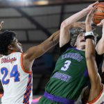 Edmonds-Woodway’s Grant Williams yells as he leaps in the air to try and make a shot during the 3A boys championship game against Rainier Beach on Saturday, March 8, 2025 in Tacoma, Washington. (Olivia Vanni / The Herald)