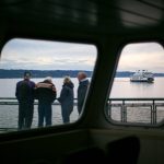 A group of travelers aboard the MV Suquamish watch from the sun deck as MV Tokitae passes starboard side on Thursday, Sept. 7, 2023, in the waters near Clinton, Washington. (Ryan Berry / The Herald)
