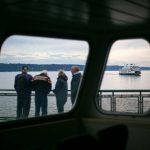 A group of travelers aboard the MV Suquamish watch from the sun deck as MV Tokitae passes starboard side on Thursday, Sept. 7, 2023, in the waters near Clinton, Washington. (Ryan Berry / The Herald)