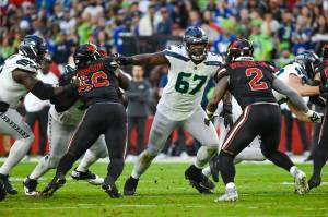 Seahawks left tackle Charles Cross (67) and his fellow offensive linemen block against the Arizona Cardinals at State Farm Stadium on Sunday, Dec. 8, 2024. Seattle has not addressed interior offensive line issues during the first few days of free agency negotiations. (Photo courtesy of Edwin Hooper / Seattle Seahawks)