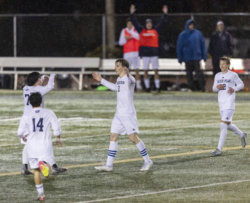Glacier Peaks Federico Zamolo puts his arms up in celebration after scoring from near the 50 yard line during the game against Snohomish on Wednesday, March 12, 2025 in Snohomish, Washington. (Olivia Vanni / The Herald)
