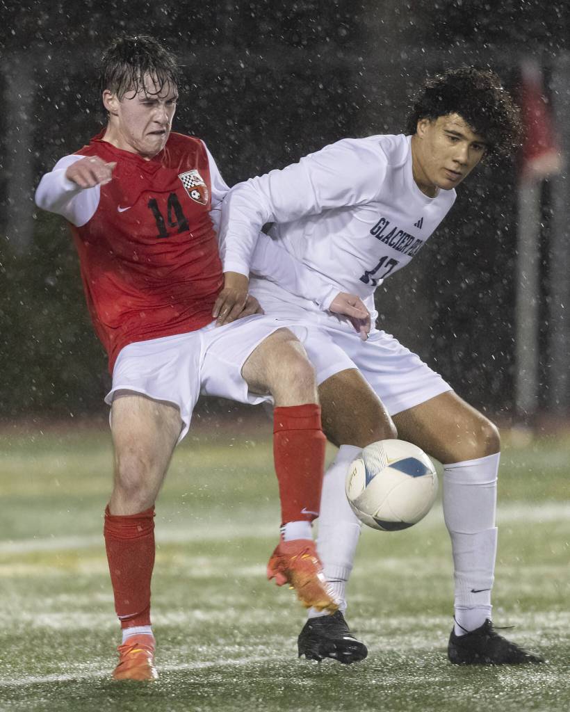Snohomishs Colton Moores and Glacier Peaks Joziah Coppin go after the ball during the game on Wednesday, March 12, 2025 in Snohomish, Washington. (Olivia Vanni / The Herald)