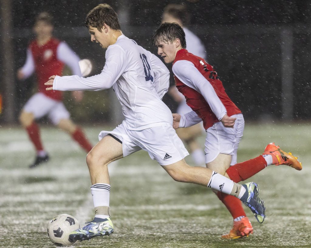 Glacier Peaks Tyler Larsen dribbles the ball down the field during the game against Snohomish on Wednesday, March 12, 2025 in Snohomish, Washington. (Olivia Vanni / The Herald)
