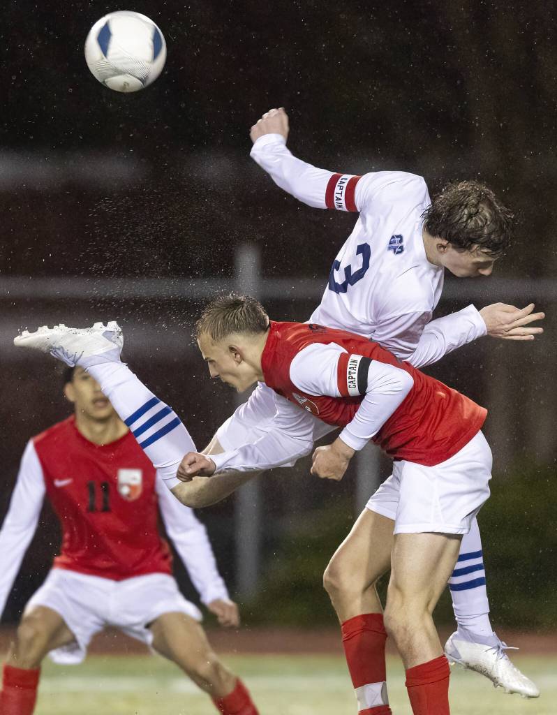 Glacier Peaks Federico Zamolo collides with a Snohomish player as he leaps in the air for the ball during the game on Wednesday, March 12, 2025 in Snohomish, Washington. (Olivia Vanni / The Herald)