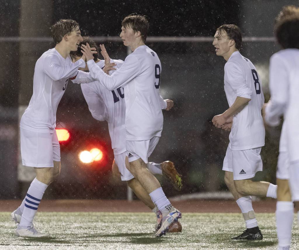 Glacier Peaks Tate Swetman is congratulated by his teammates after scoring during the game against Snohomish on Wednesday, March 12, 2025 in Snohomish, Washington. (Olivia Vanni / The Herald)