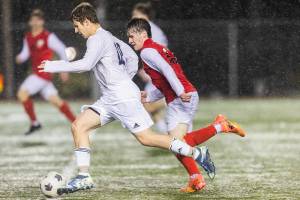 Glacier Peak’s Tyler Larsen dribbles the ball down the field during the game against Snohomish on Wednesday, March 12, 2025 in Snohomish, Washington. (Olivia Vanni / The Herald)