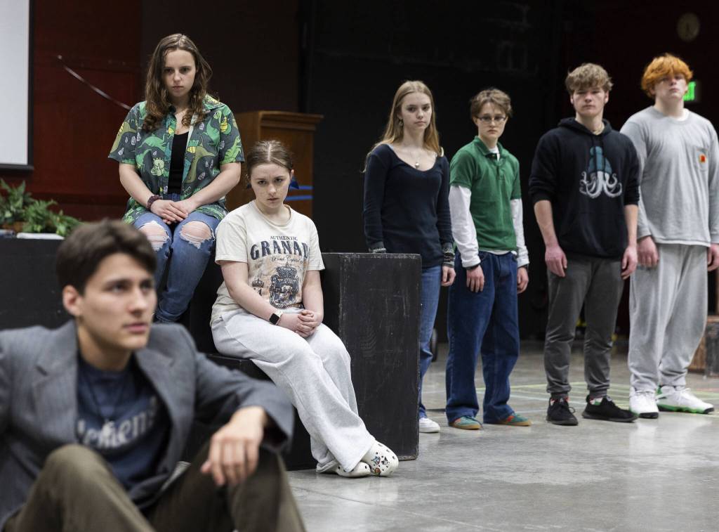 The Loud Stone and Little Stone characters stare down Eurydices father, played by Tyler Pennington during a full run-through at rehearsal on Monday, March 17, 2025, at Meadowdale High School in Lynnwood, Washington. (Olivia Vanni / The Herald)