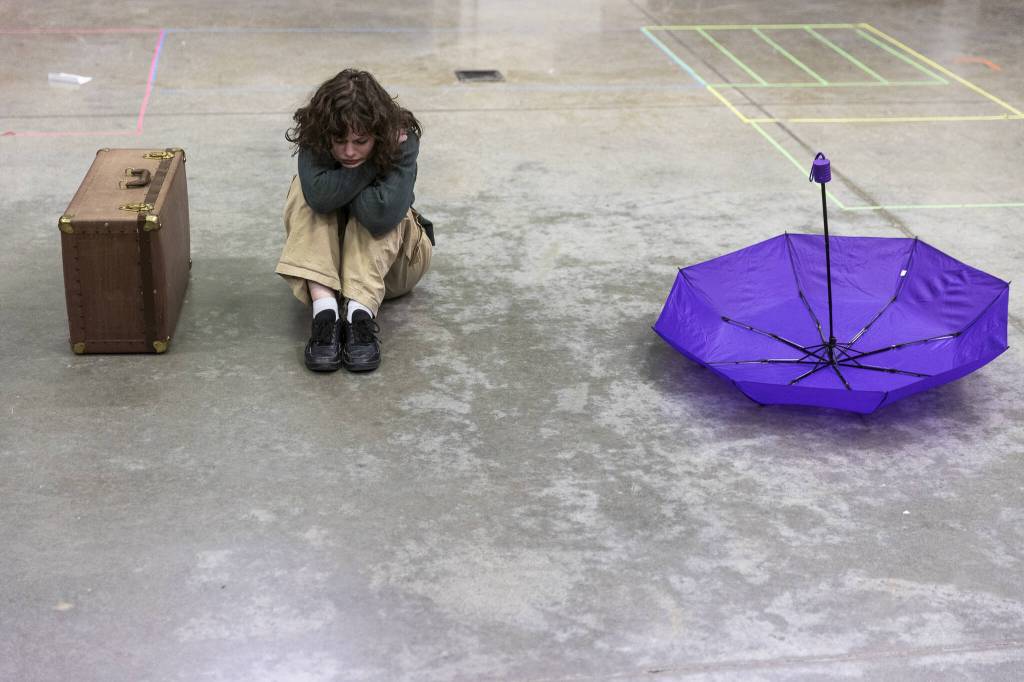 Lucy Knudson, who plays Eurydice, sits on the floor while in character during a full run-through of the play at rehearsal on Monday, March 17, 2025, at Meadowdale High School in Lynnwood, Washington. (Olivia Vanni / The Herald)