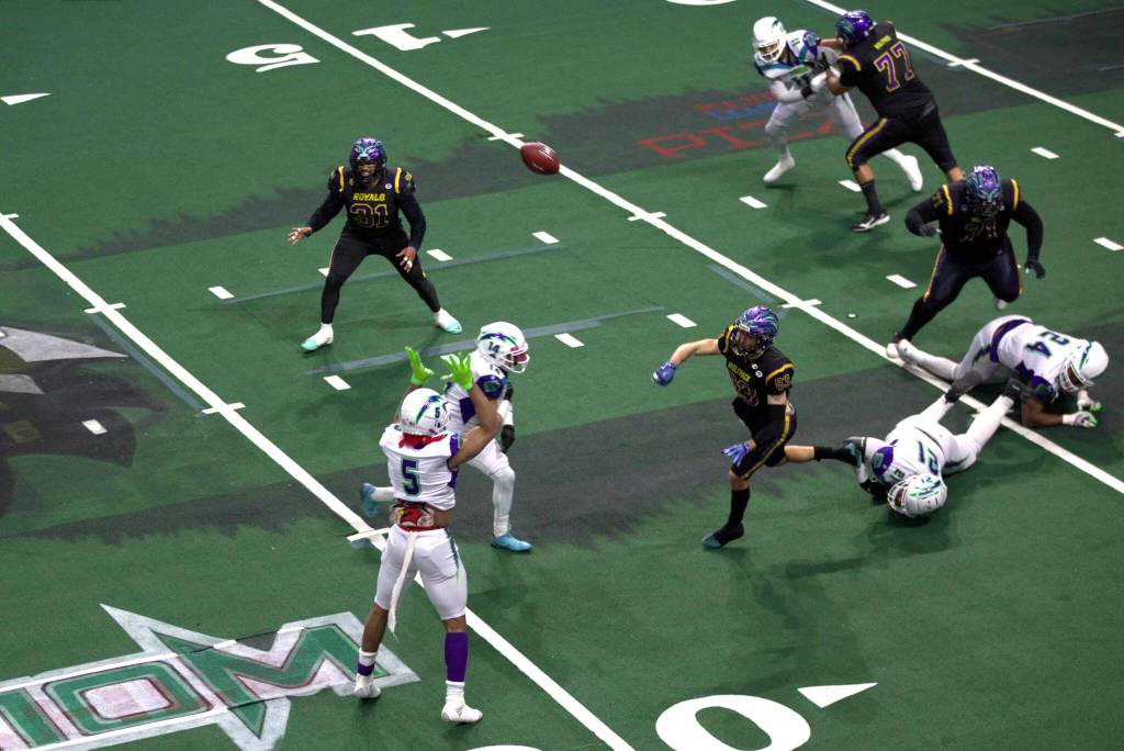 Wolfpack quarterback Adam Kruse (83) throws his teams first touchdown pass of the season in a 63-33 loss at Angel of the Winds Arena on March 16, 2025. (Aaron Coe / The Herald)