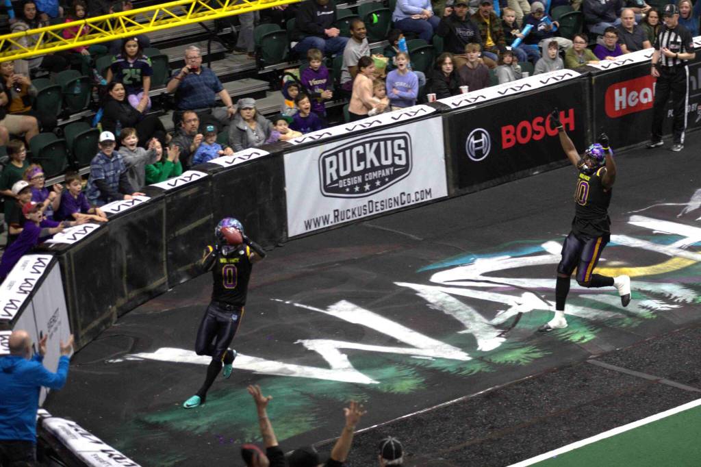 Josh Meier (0) catches a touchdown pass as Ledarian McAllister (10) celebrates during the Washington Wolfpacks 63-33 loss at Angel of the Winds Arena on March 16, 2025. (Aaron Coe / The Herald)