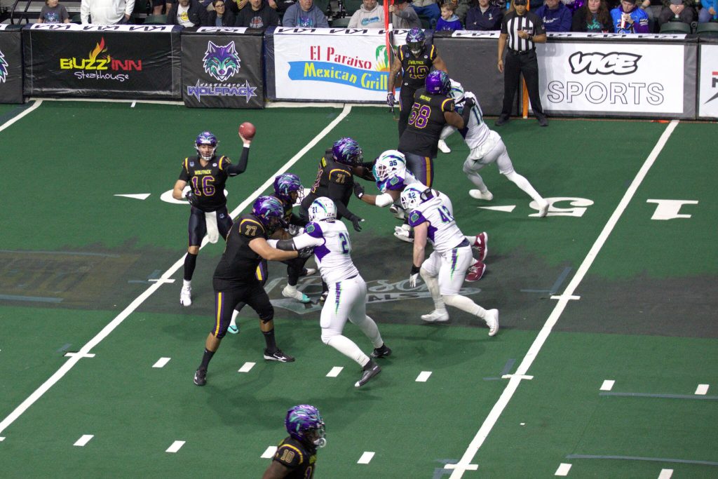 Quarterback Joe Hess (16) throws a pass during the first quarter of the Washington Wolfpacks 63-33 loss at Angel of the Winds Arena on March 16, 2025. (Aaron Coe / The Herald)