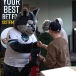 Apollo, the Washington Wolfpacks mascot, greets a fan prior to the season opener at Angel of the Winds Arena on March 16, 2025. (Aaron Coe / The Herald)