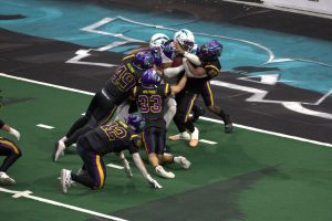 Southwest Kansas Storm quarterback Jalen Morton (7) bulls his way into the end zone on fourth down in the first quarter of the Washington Wolfpack's 63-33 loss at Angel of the Winds Arena on March 16, 2025. (Aaron Coe / The Herald)