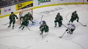 Everett Silvertips winger Dominik Rymon (center) drives toward the puck after a failed Wenatchee shot in Everett's 5-0 win against the Wild in Everett, Washington on March 21, 2025. Rymon is flanked by, from left to right, defenseman Landon DuPont, winger Jesse Heslop, defenseman Eric Jamieson and center Julius Miettinen, while goalie Jesse Sanche is squared in net behind them. (Joe Pohoryles / The Herald)