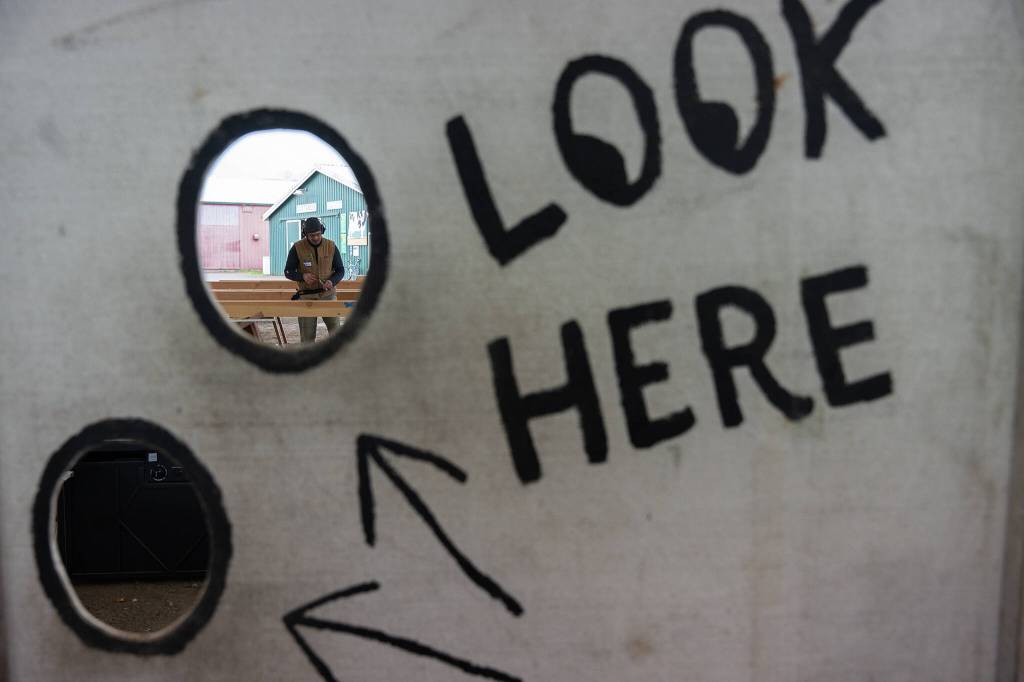 Nathan Poage works with the Timber Framers Guild on Wednesday, March 19 in Monroe, Washington to create a community gathering space. (Will Geschke / The Herald)