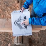 Elaina Jorgensen points to a design of the gathering space on Wednesday in Monroe.