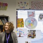 Dr. Katie Gilligan, the chief medical officer at Compass Health who oversees the treatment center in Mukilteo, stands in the facilities multi-purpose room covered in artwork on Monday, March 24, 2025 in Mukilteo, Washington. (Olivia Vanni / The Herald)