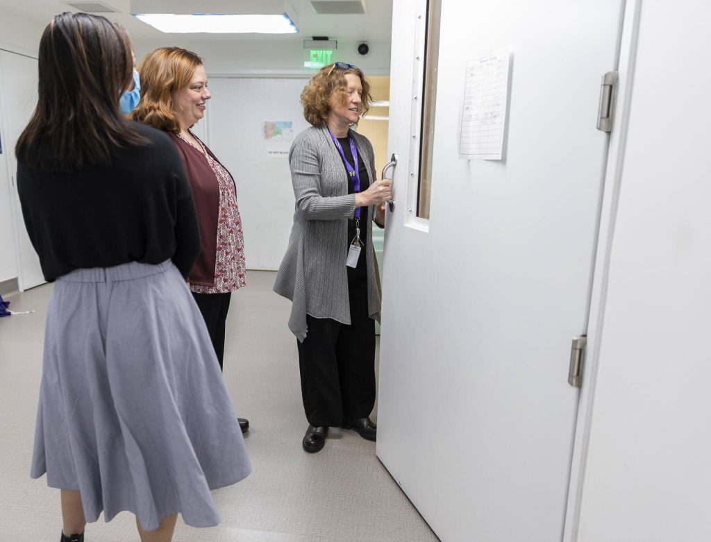 Dr. Katie Gilligan opens one of the seclusion rooms in the Mukilteo Evaluation and Treatment Center on Monday, March 24, 2025 in Mukilteo, Washington. (Olivia Vanni / The Herald)