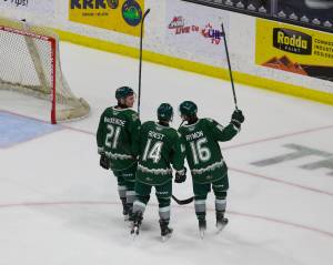 Everett Silvertips overage forwards (from left to right) Tyler MacKenzie, Austin Roest and Dominik Rymon take a lap and salute the crowd at Angel of the Winds Arena after winning the regular season home finale 5-0 against the Wenatchee Wild in Everett, Washington on March 21, 2025. WHL teams are allowed just three 20-year-old -- or 'overage' -- players on their roster, and the trio's WHL careers will end following the Silvertips' upcoming postseason. (Joe Pohoryles / The Herald)